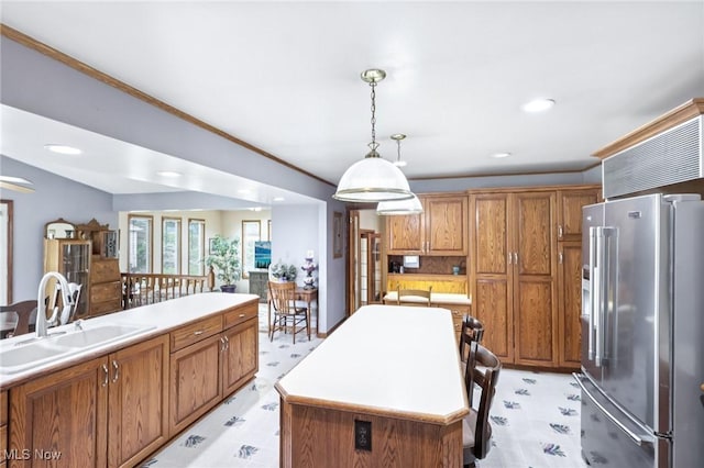 1318 Mirheath Dr, Huron, OH 44839 - kitchen featuring high end fridge, brown cabinetry, light countertops, decorative light fixtures, and light floors