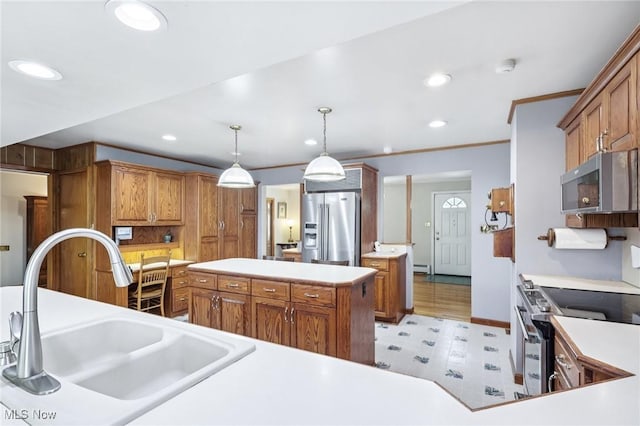 1318 Mirheath Dr, Huron, OH 44839 - kitchen with stainless steel appliances, brown cabinetry, recessed lighting, light countertops, and hanging light fixtures