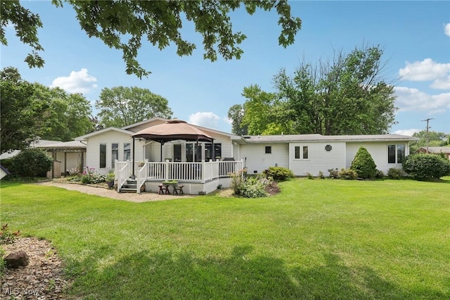 1318 Mirheath Dr, Huron, OH 44839 - back of property featuring a gazebo, a deck, and a lawn