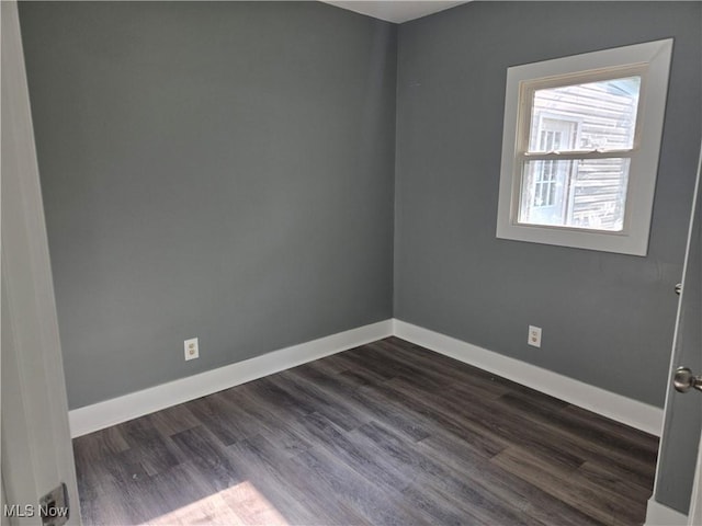 2500 Redgate Ln, Austintown, OH 44511 - spare room with baseboards and dark wood-type flooring