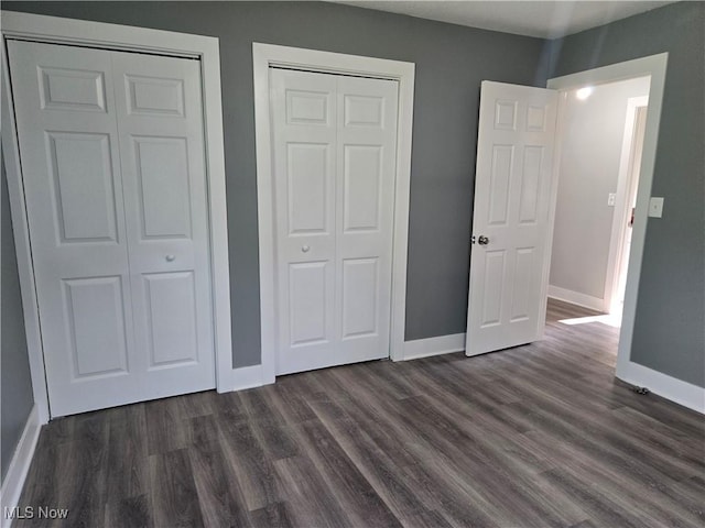 2500 Redgate Ln, Austintown, OH 44511 - unfurnished bedroom with baseboards and dark wood-style flooring