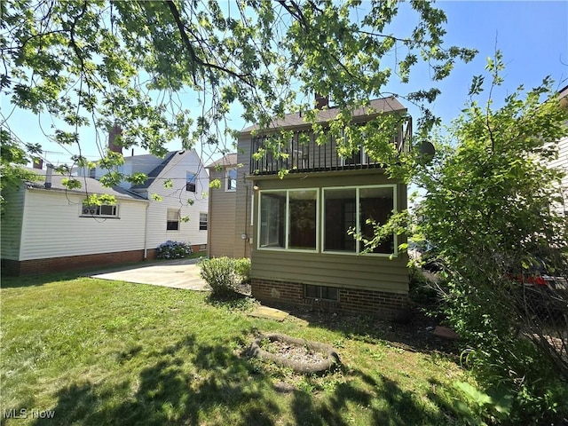 26313 Oriole Ave, Euclid, OH 44132 - rear view of property featuring a lawn and a patio area