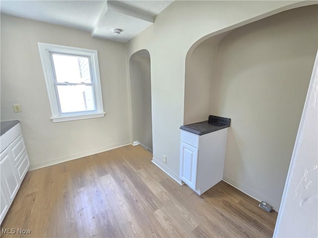 26313 Oriole Ave, Euclid, OH 44132 - unfurnished dining area featuring light wood-type flooring and arched walkways