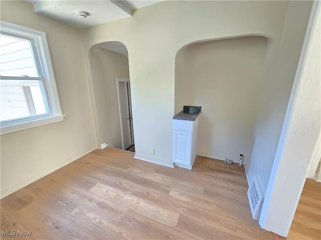 26313 Oriole Ave, Euclid, OH 44132 - empty room featuring arched walkways, light wood finished floors, and a smoke detector