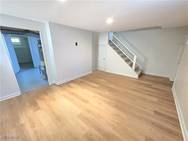 26313 Oriole Ave, Euclid, OH 44132 - below grade area with stairway, light wood-style flooring, and water heater