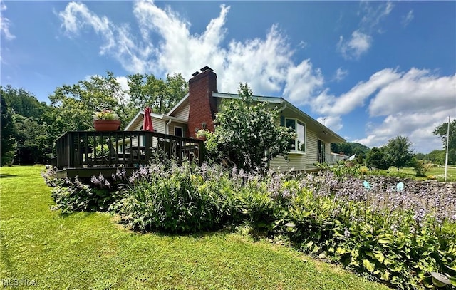 4145 Old River Rd, Philo, OH 43771 - view of home's exterior with a yard, a wooden deck, and a chimney