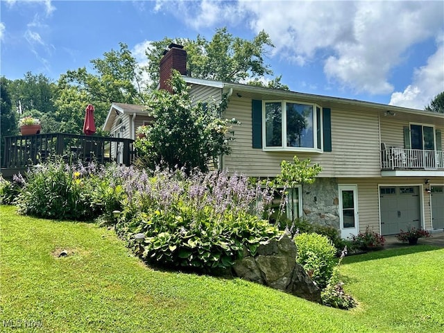 4145 Old River Rd, Philo, OH 43771 - view of side of home with a chimney, a lawn, and an attached garage