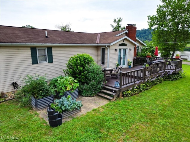 4145 Old River Rd, Philo, OH 43771 - back of house with a deck, a lawn, a garden, a chimney, and french doors