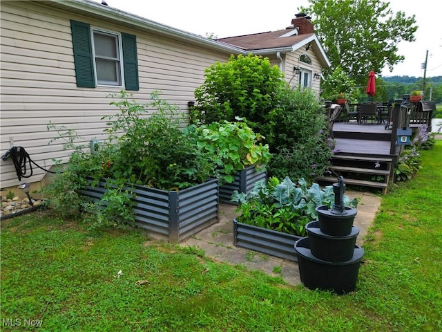 4145 Old River Rd, Philo, OH 43771 - view of green lawn featuring a wooden deck and a vegetable garden