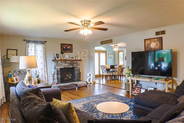 4145 Old River Rd, Philo, OH 43771 - living area featuring ceiling fan, healthy amount of natural light, wood finished floors, and a fireplace