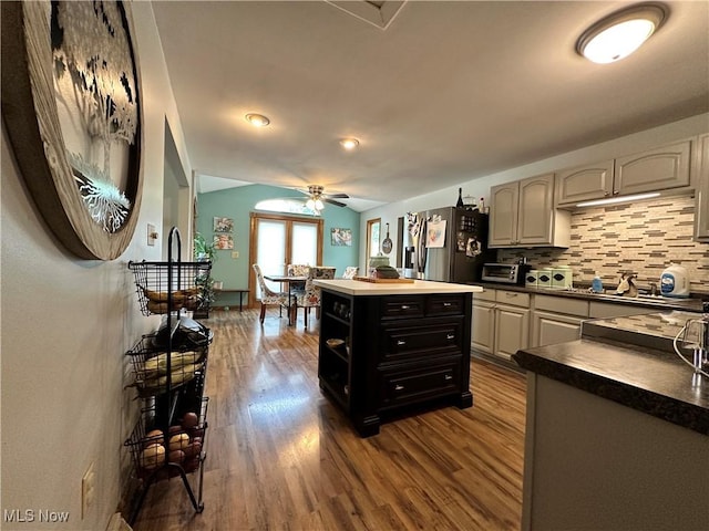 4145 Old River Rd, Philo, OH 43771 - kitchen with stainless steel appliances, a ceiling fan, dark wood finished floors, tasteful backsplash, and vaulted ceiling