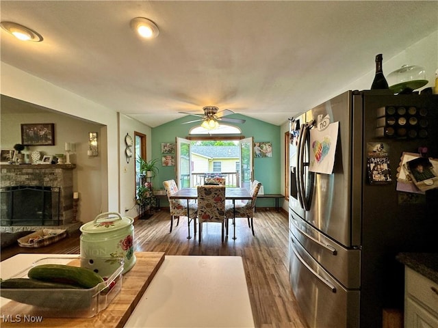 4145 Old River Rd, Philo, OH 43771 - dining room featuring dark wood-type flooring, vaulted ceiling, ceiling fan, and a fireplace with raised hearth