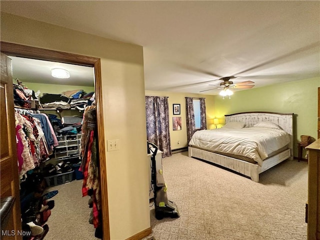 4145 Old River Rd, Philo, OH 43771 - bedroom with carpet floors, a spacious closet, a ceiling fan, and baseboard heating
