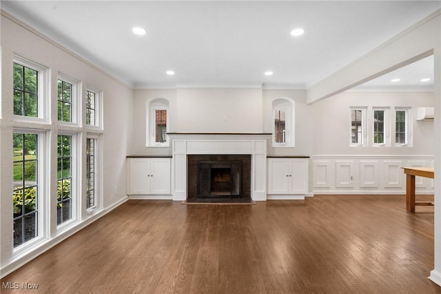18112 Lomond Blvd, Shaker Heights, OH 44122 - unfurnished living room with wood finished floors, a wall mounted air conditioner, a fireplace with flush hearth, crown molding, and recessed lighting