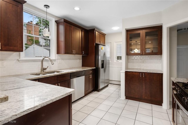 18112 Lomond Blvd, Shaker Heights, OH 44122 - kitchen with stainless steel appliances, tasteful backsplash, light stone countertops, glass insert cabinets, and recessed lighting