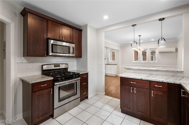 18112 Lomond Blvd, Shaker Heights, OH 44122 - kitchen featuring stainless steel appliances, an AC wall unit, dark brown cabinetry, hanging light fixtures, and backsplash