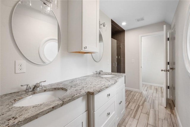 18112 Lomond Blvd, Shaker Heights, OH 44122 - full bathroom featuring double vanity, recessed lighting, and wood finish floors