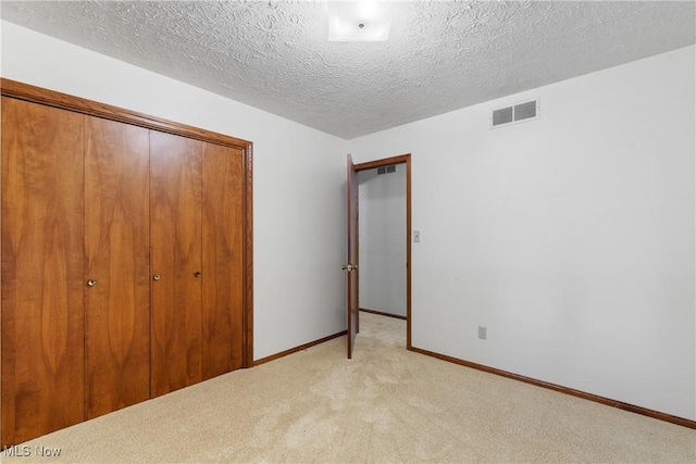 120 Vineyard Way, Doylestown, OH 44230 - unfurnished bedroom featuring a closet, light colored carpet, and a textured ceiling