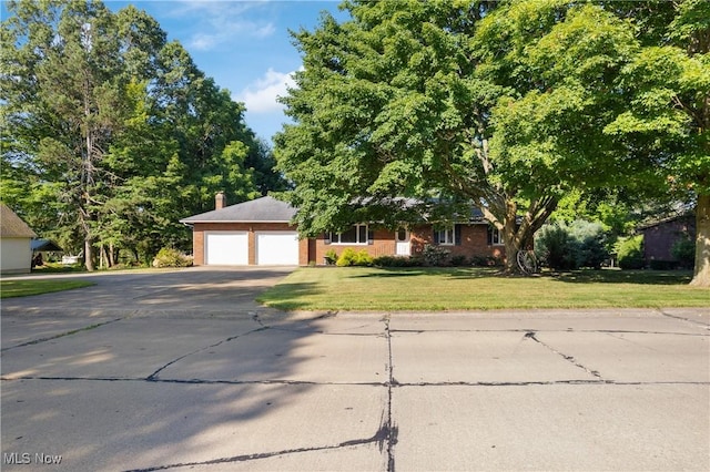 120 Vineyard Way, Doylestown, OH 44230 - view of front facade with asphalt driveway, a front lawn, a chimney, and an attached garage