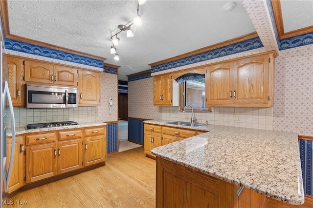120 Vineyard Way, Doylestown, OH 44230 - kitchen with appliances with stainless steel finishes, crown molding, wallpapered walls, light wood finished floors, and a peninsula