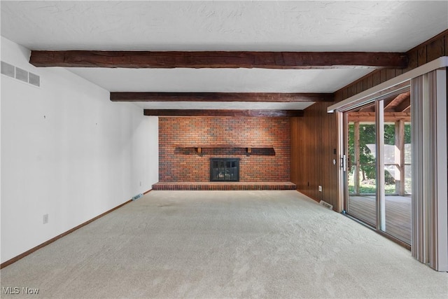 120 Vineyard Way, Doylestown, OH 44230 - unfurnished living room featuring a brick fireplace, carpet floors, beam ceiling, and wood walls