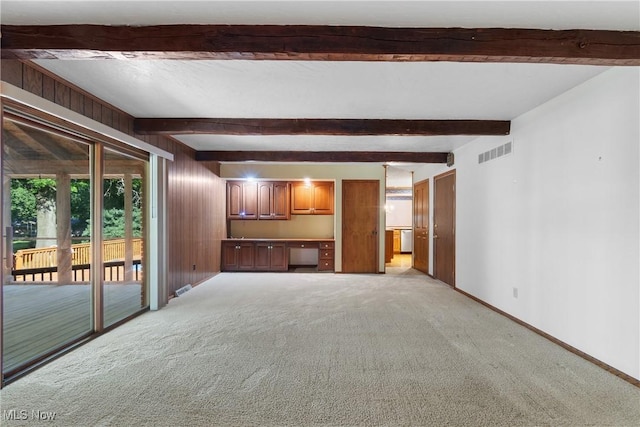 120 Vineyard Way, Doylestown, OH 44230 - unfurnished living room featuring built in desk, light carpet, and beamed ceiling