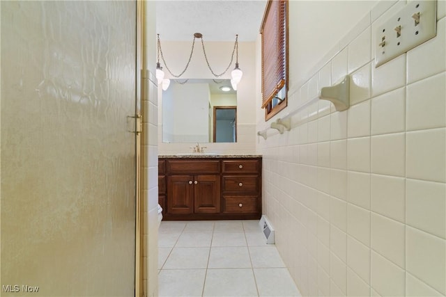 120 Vineyard Way, Doylestown, OH 44230 - bathroom with a stall shower, vanity, tile patterned floors, and tile walls