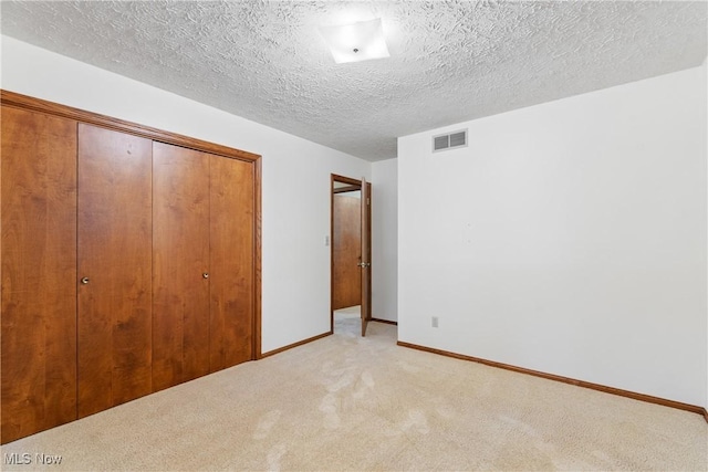 120 Vineyard Way, Doylestown, OH 44230 - unfurnished bedroom with a closet, light carpet, and a textured ceiling
