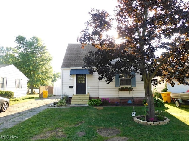 3233 Wilson Ave, Ashtabula, OH 44004 - view of front of property featuring a front yard, a shingled roof, and entry steps
