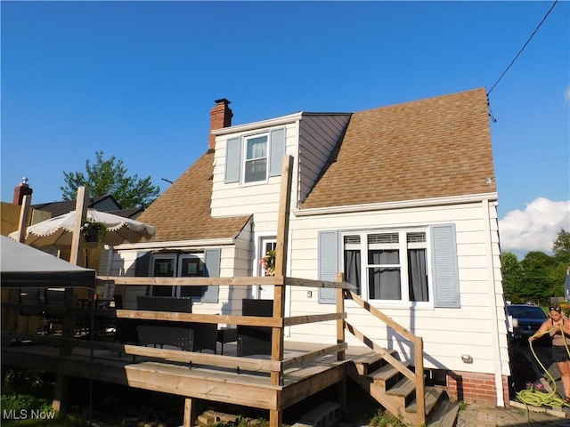 3233 Wilson Ave, Ashtabula, OH 44004 - back of house featuring a wooden deck, a chimney, and roof with shingles