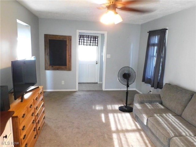 3233 Wilson Ave, Ashtabula, OH 44004 - carpeted living area featuring a ceiling fan and baseboards