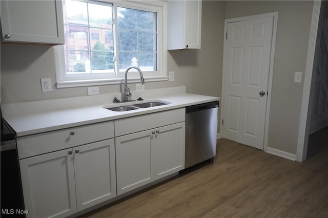 124 Peeler St, Mingo Junction, OH 43938 - kitchen featuring stainless steel dishwasher, wood finished floors, light countertops, and white cabinets