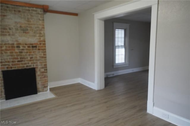 124 Peeler St, Mingo Junction, OH 43938 - unfurnished living room with wood finished floors and a fireplace