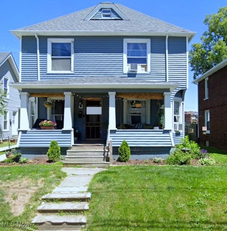 129 S Pardee St, Wadsworth, OH 44281 - view of front of house with a porch, a front lawn, and a shingled roof