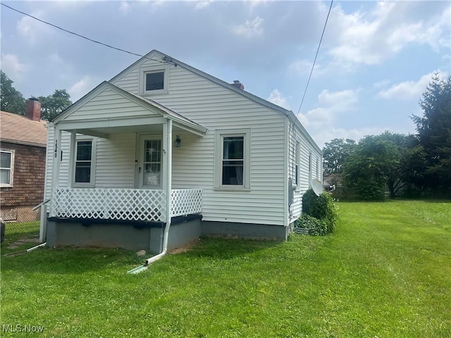 1540 Tanner Ave SW, Canton, OH 44706 - back of house with a lawn and a porch