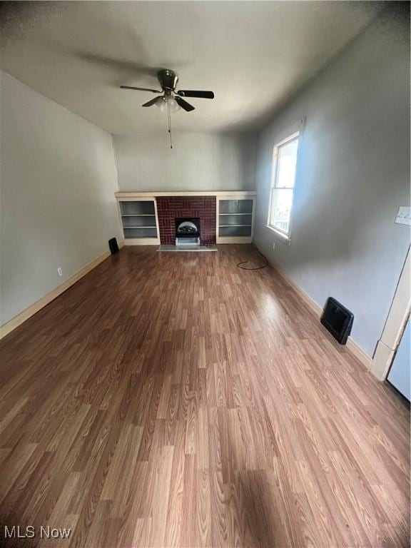 1370 Lee Ct SW, Canton, OH 44706 - unfurnished living room featuring a ceiling fan, wood finished floors, and a fireplace