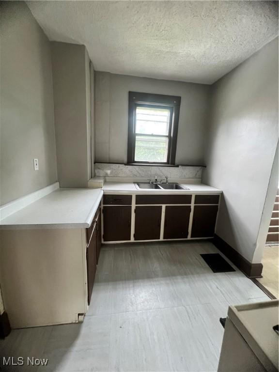 1370 Lee Ct SW, Canton, OH 44706 - kitchen featuring light countertops and a textured ceiling