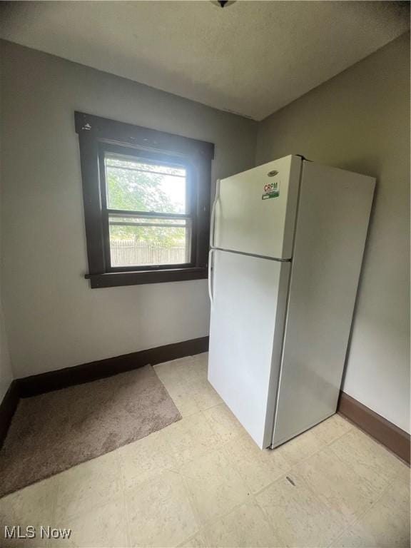 1370 Lee Ct SW, Canton, OH 44706 - kitchen featuring freestanding refrigerator and baseboards