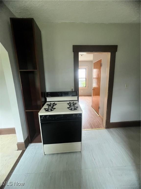 1370 Lee Ct SW, Canton, OH 44706 - kitchen with gas stove and a textured ceiling