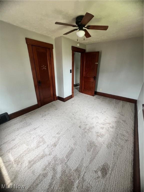 1370 Lee Ct SW, Canton, OH 44706 - unfurnished bedroom with carpet floors, a closet, and a ceiling fan