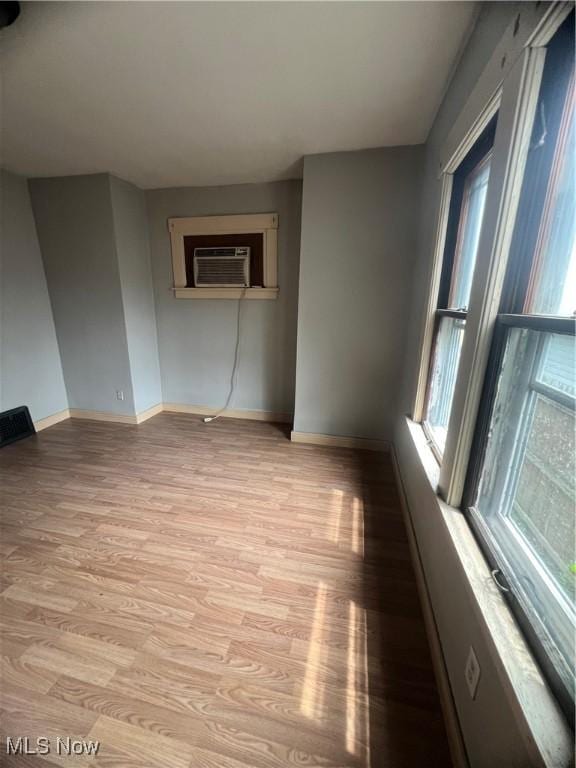 1370 Lee Ct SW, Canton, OH 44706 - unfurnished room with a wall unit AC and light wood-style flooring