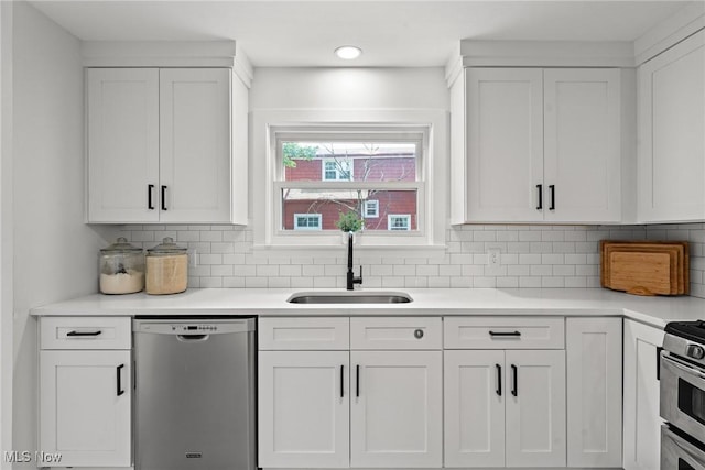 1361 Plainfield Rd, South Euclid, OH 44121 - kitchen with stainless steel appliances, white cabinets, light countertops, and backsplash