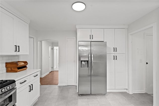 1361 Plainfield Rd, South Euclid, OH 44121 - kitchen featuring appliances with stainless steel finishes, light countertops, and white cabinetry