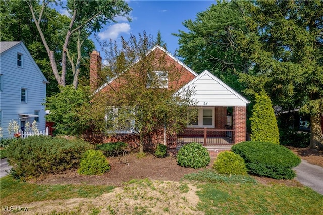 1361 Plainfield Rd, South Euclid, OH 44121 - view of front of property with brick siding, a porch, and a chimney