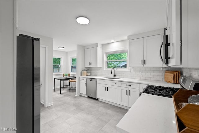 1361 Plainfield Rd, South Euclid, OH 44121 - kitchen featuring stainless steel appliances, backsplash, light countertops, and white cabinets