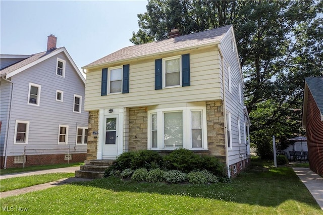 234 E 218th St, Euclid, OH 44123 - view of front of property with stone siding, a front lawn, and a chimney