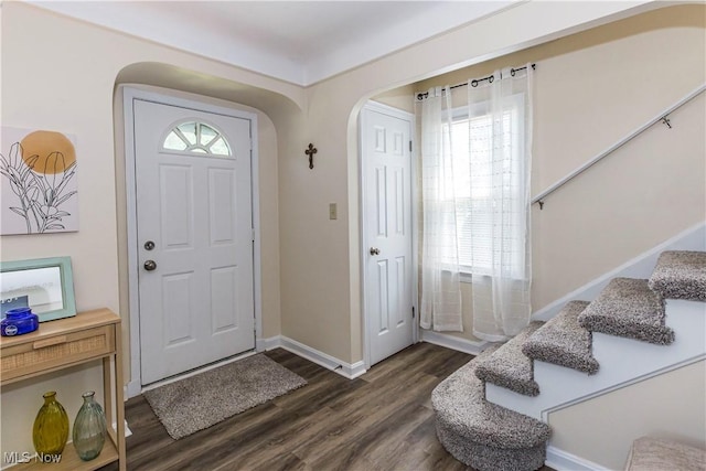 234 E 218th St, Euclid, OH 44123 - entryway with dark wood-style flooring, stairs, and arched walkways