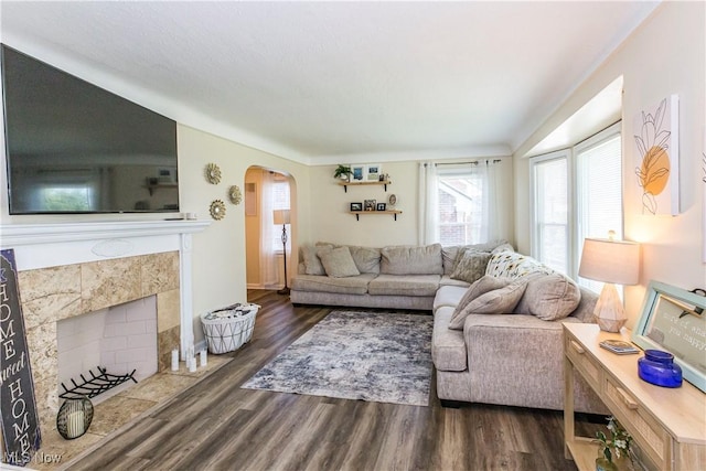 234 E 218th St, Euclid, OH 44123 - living area featuring arched walkways, wood finished floors, and a tile fireplace