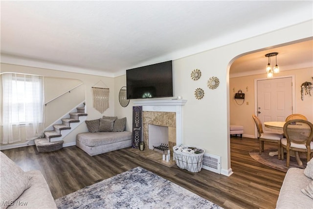 234 E 218th St, Euclid, OH 44123 - living area with arched walkways, wood finished floors, stairs, and a fireplace