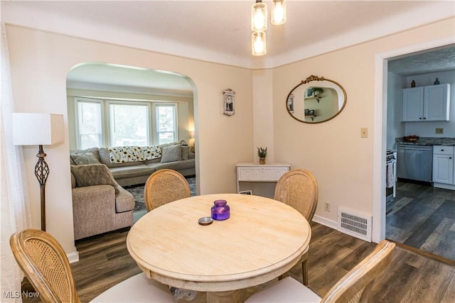 234 E 218th St, Euclid, OH 44123 - dining space with arched walkways and dark wood-style floors
